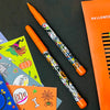 Halloween-themed pen with orange cap on a black background